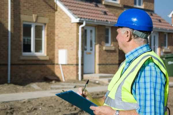 Surveyor and adjoining owner discussing property boundaries